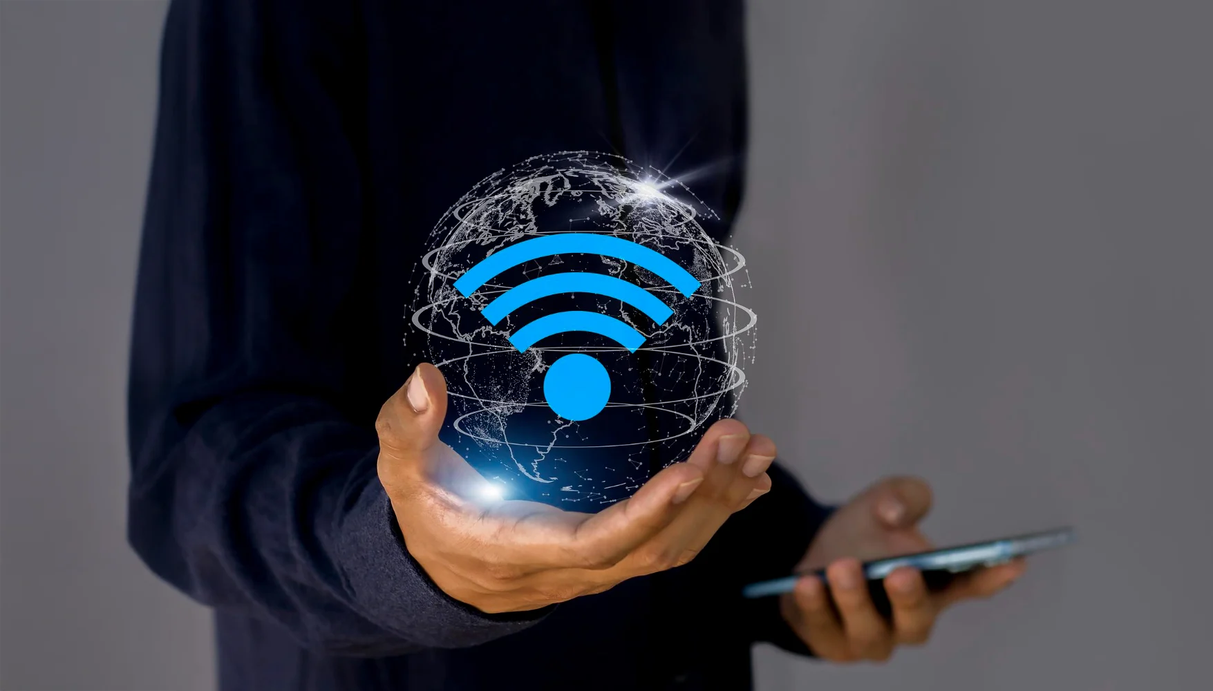 Hand holding a digital globe with Wi-Fi symbol.