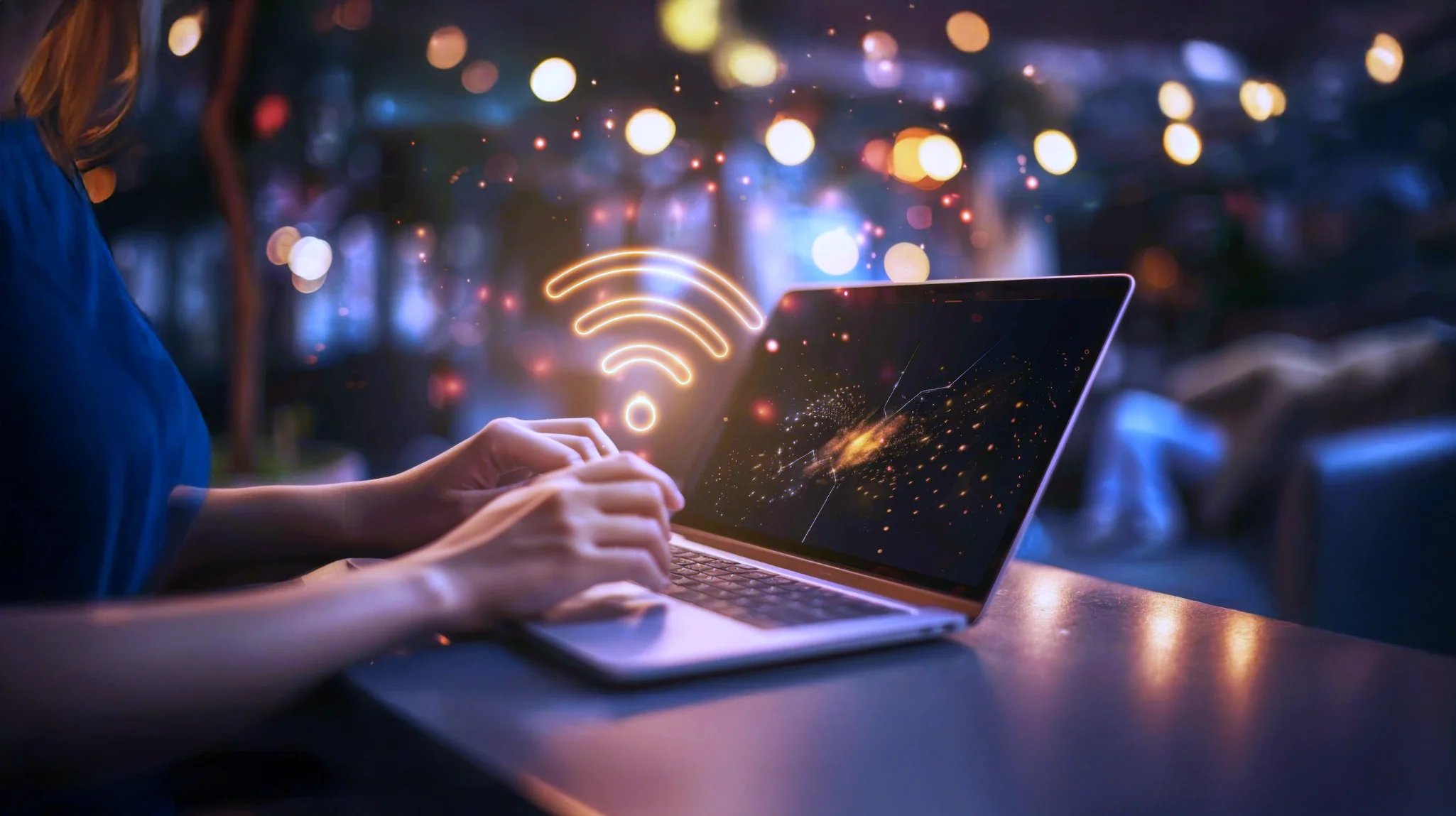 Person using laptop with glowing WiFi symbol