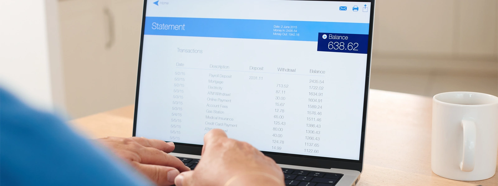 Person reviewing financial statement on laptop.