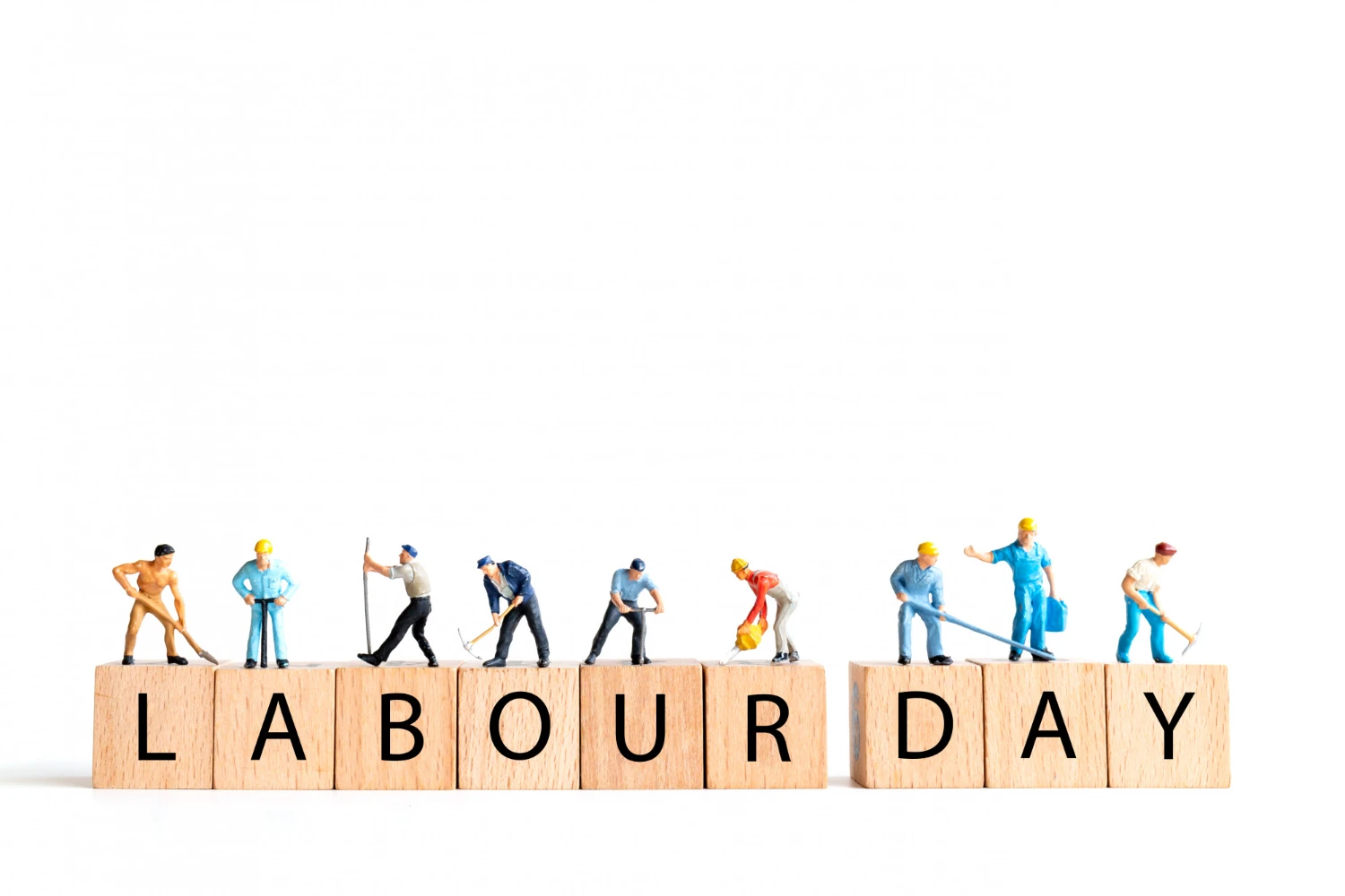 Mini workers celebrating Labor Day with wooden blocks